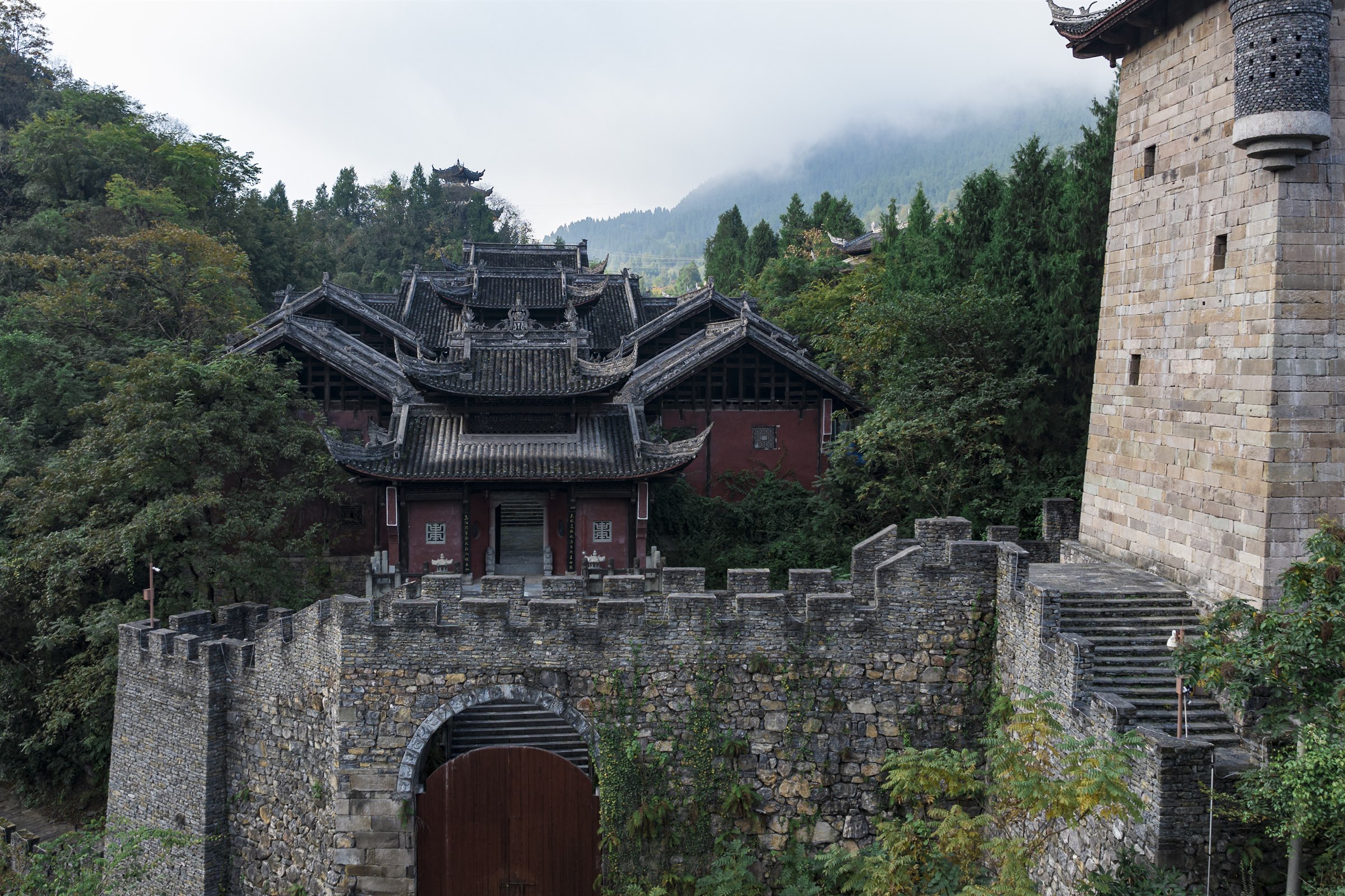 Traditional gate and mountain scenery at Jiuli City